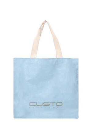 Hellblaue Tragetasche mit beigen Griffen und dem Wort "CUSTO BARCELONA" in Grau auf der vorderen unteren Mittelposition gedruckt.