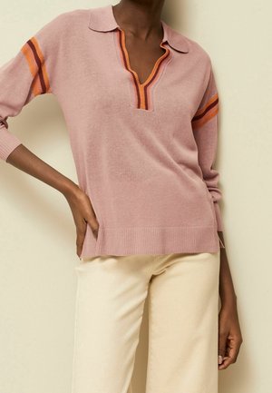 Jasnoróżowy sweter dziany z dekoltem w serek, złożonym kołnierzem i pomarańczowymi paskami na rękawach. Prążkowany dół i rozcięcia po bokach.