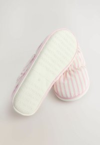 Soft pink and white striped slippers, featuring a cushioned upper and textured sole with 'NEXT' embossing, designed for comfort and warmth.