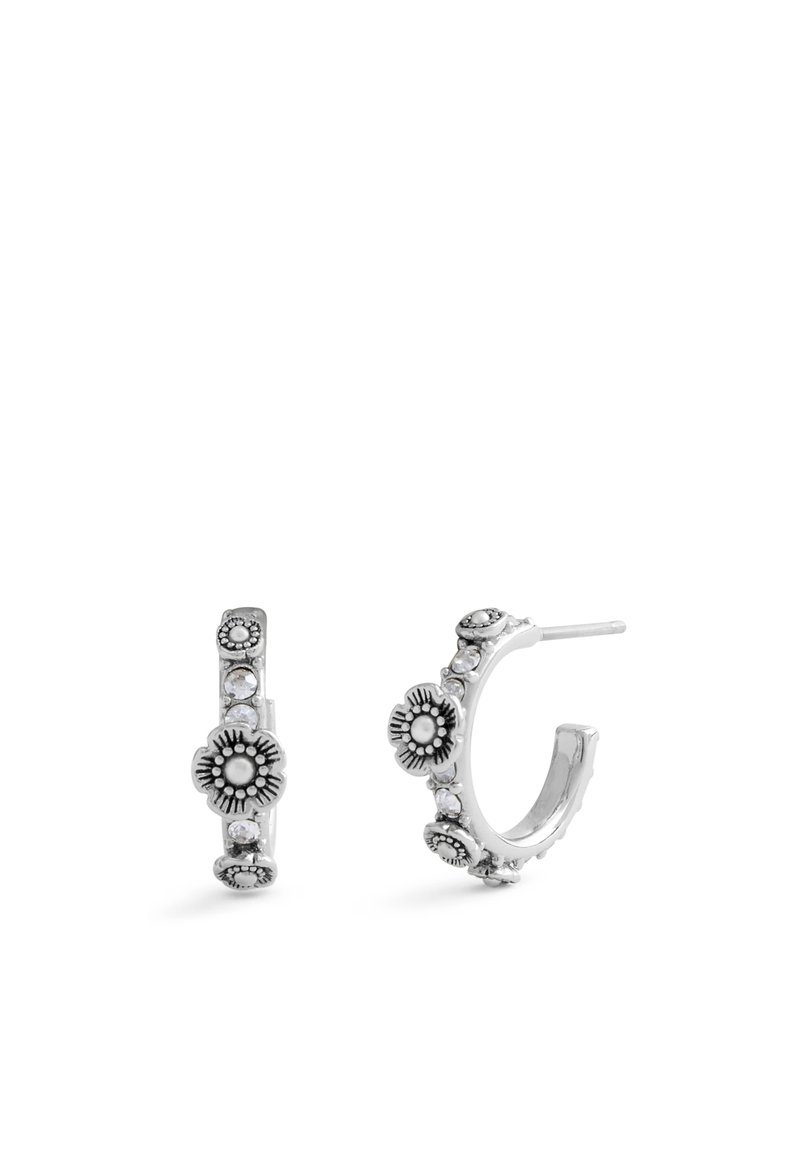 Silver hoop earrings adorned with floral patterns, small clear crystals, and intricate detailing along the outer edge.