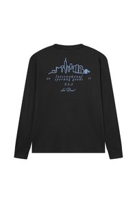 Μαύρο πουκάμισο με μακριά μανίκια με γραφικό μπλε ορίζοντα και κείμενο "Διεθνή αθλητικά είδη 2011 Η.Π.Α. Les Deux" στην πλάτη.