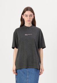 Tamsiai pilkas XXL t-shirt'as su trumpomis rankovėmis, turintis subtilią dėmėtą tekstūrą ir logotipą "KARL LAGERFELD JEANS" ant krūtinės.