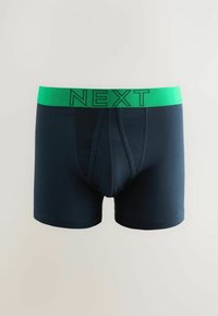 Temno modri boksarji z zelenim elastičnim pasom, na katerem je logo "NEXT". Gladek material, dolžina do sredine stegen in oblikovan sprednji del.