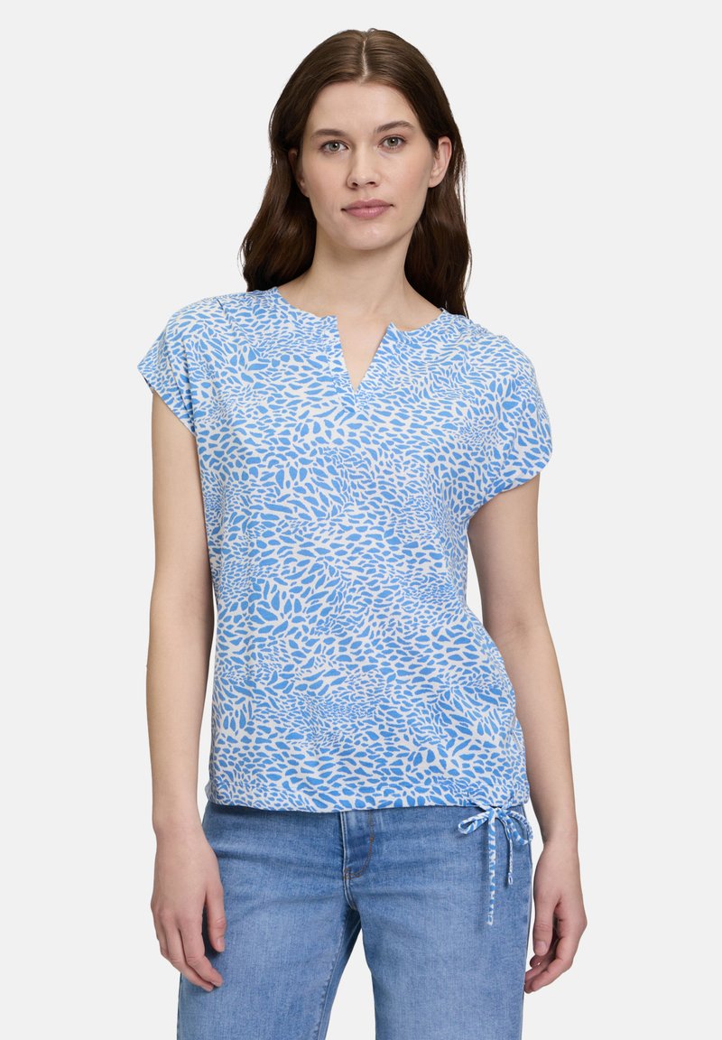 Blue short-sleeve top with a V-neck, featuring a textured abstract pattern in varying shades of blue and a drawstring hem.
