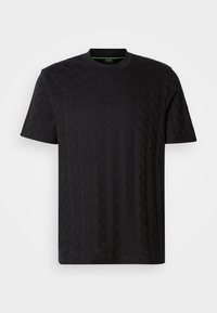 T-shirt noir à manches courtes avec motif géométrique subtil, col rond et petit logo BOSS sur la poitrine, présenté sur fond uni.