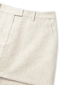 Jupe en lin beige avec une finition texturée, dotée d'une taille plate, de poches avant et d'une coupe ajustée.
