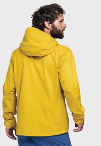 Gelbe wasserdichte Jacke mit Kapuze, langen Ärmeln, strukturiertem Stoff und lockerer Passform. Die Rückansicht zeigt ein elegantes Design und Nähte.