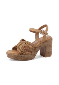 Sandalina piatta marrone con texture intrecciate, fasce incrociate, cinturino alla caviglia con fibbia e tacco spesso.