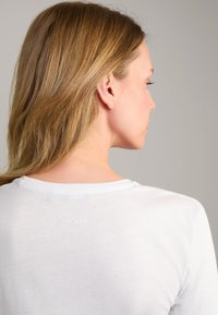 White T-shirt made of soft fabric, featuring a round neckline and a small "JOOP!" logo printed in light color on the back.