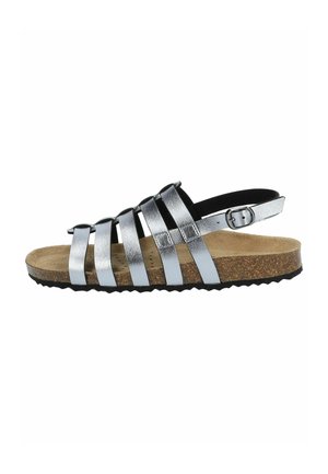 Sandalo con cinturini realizzato in materiale metallico argentato con soletta in sughero. Presenta una fascia sul retro e una suola in gomma nera testurizzata.