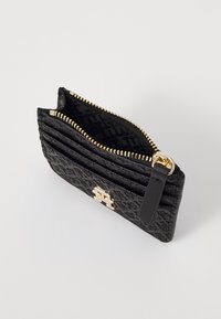 Black textured leather cardholder with gold zipper and hardware, featuring multiple card slots and a logo detail on the front.