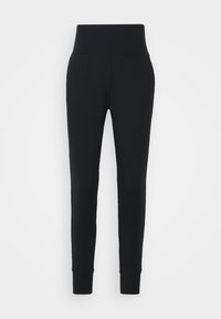 Svarta leggings i stretchigt material. Hög midja, smalnande ben och åtsittande muddar vid vristerna. Inga mönster eller detaljer.