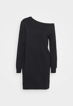 Robe noire à manches longues avec un décolleté asymétrique, comprenant une découpe à une épaule et des poignets ainsi qu'un ourlet côtelés.