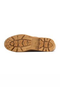 Semelle en caoutchouc avec un design texturé brun, comportant des rainures profondes et un motif pour l'adhérence. Des zones renforcées améliorent la durabilité.