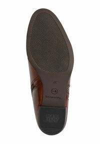 Sole of a brown leather shoe with textured anti-slip rubber grip and block heel, size 37, showing brand markings and stitch details.