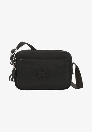 Černá nylonová crossbody taška se zipovým uzávěrem, s logem na nášivce a nastavitelným popruhem. Součástí je malý klíčový řetěz s opicí.