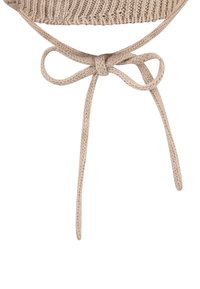 Beige knitted fabric tied in a neat bow with two long, hanging braided cords on a plain white background.