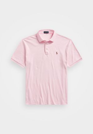 Light pink polo shirt made of cotton. Short sleeves, collar with three button placket, and a small embroidered logo on the chest.
