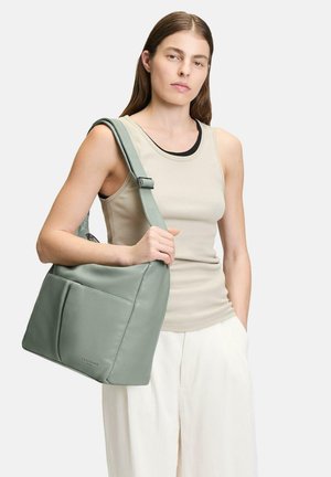 Green leather shoulder bag with a smooth texture, featuring a structured shape, adjustable strap, and front pocket detail.
