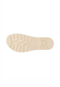 Suola di scarpa in gomma beige con motivo testurizzato di presa, caratterizzata da scanalature e rientranze per la trazione. Design con punta e tacco arrotondati e piatti.