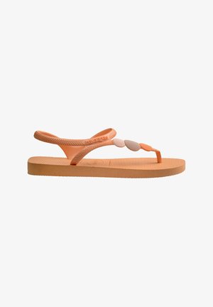 Infradito arancioni in gomma con cinturini testurizzati e suola piatta. Presentano dettagli decorativi lungo il cinturino. Logo Havaianas visibile.