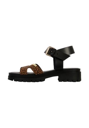 Black leather sandal with a leopard print footbed, featuring a wide ankle strap with a buckle, and a rugged, textured black sole.