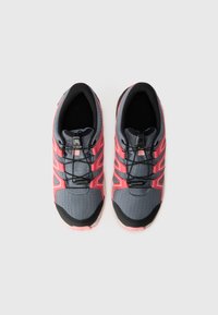 Gray and pink athletic shoes with a textured surface, elastic laces, and a black accent at the toe. Lightweight design for running.