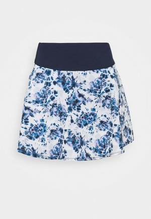 Rock mit breitem dunkelblauem Taillenbund und weißem Stoff mit blau-schwarzem Blumenmuster.