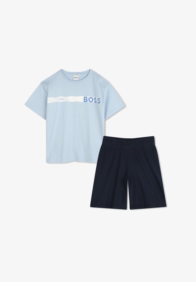 Világoskék rövid ujjú póló fehér csíkkal és kék "BOSS" logóval, sötét tengerészkék, elasztikus derékú sorttal párosítva. Pamut keverék.
