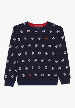 Granatowa bluza z długim rękawem z białymi kwiatowymi logo na całej powierzchni oraz dwoma małymi czerwonymi kwiatowymi logo, z czerwonym wykończeniem wewnętrznego kołnierza.