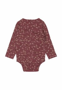 Långärmad bodysuit i vinröd med ett blommönster i beige. Mjuk bomullsmaterial med en rundad halsringning och tryckknappar i botten.