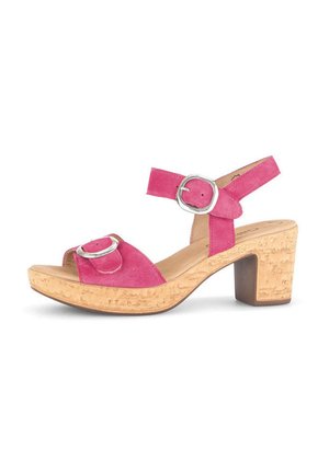 Pink suede sandal with a chunky cork heel. Features a front buckle and ankle strap, showcasing a smooth texture and rounded toe.