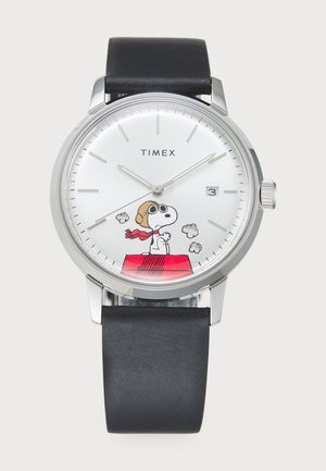 Timex watch with a silver dial displaying Snoopy in a scarf, a black leather strap, round stainless steel case, and date window at 3 o'clock.