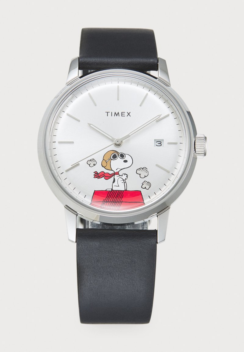 Timex watch with a silver dial displaying Snoopy in a scarf, a black leather strap, round stainless steel case, and date window at 3 o'clock.