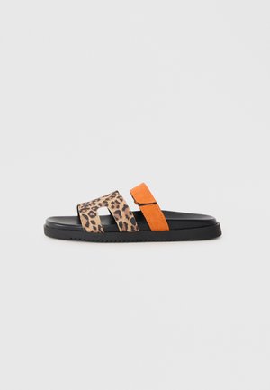 Leopard print slide sandal with orange suede accent, black sole, two wide straps, and a flat design suitable for casual wear.