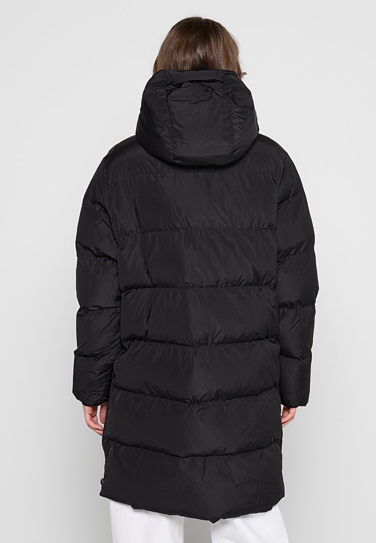 Manteau noir en duvet avec des coutures horizontales, capuche amovible et manches longues. Texture lisse, design longueur genou, adapté aux temps froids.
