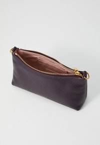 Purple leather zip pouch featuring a textured exterior, gold zipper hardware, and a light pink fabric interior with card slots.