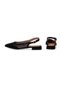 Black slingback shoes with a pointed toe, mesh detailing, and a low block heel. Features a buckle strap for an adjustable fit.