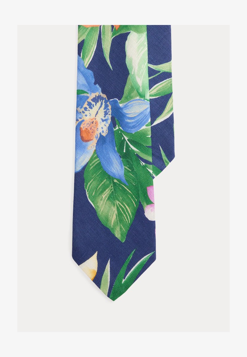 Γραβάτα με μπλε φόντο που παρουσιάζει μεγάλα πράσινα φύλλα και ζωντανά τροπικά λουλούδια σε αποχρώσεις μπλε, πορτοκαλί, ροζ και κίτρινου.