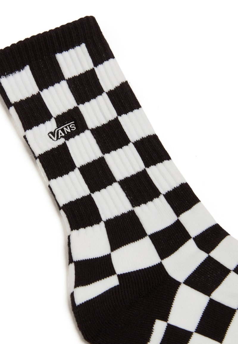 Calcetines de cuadros en blanco y negro con textura acanalada, con un pequeño logo negro de Vans en el costado.