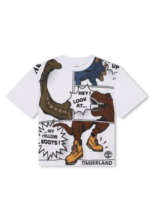T-shirt en coton blanc avec des graphismes de dinosaures colorés dans le style des comics et du texte. Graphisme notable de bottes jaunes en bas avec l'étiquette "TIMBERLAND".