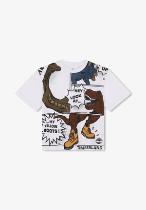 T-shirt bianco in cotone con grafiche di dinosauri in stile fumetto colorate e testo. Grafica notevole di stivali gialli in fondo con etichetta "TIMBERLAND".