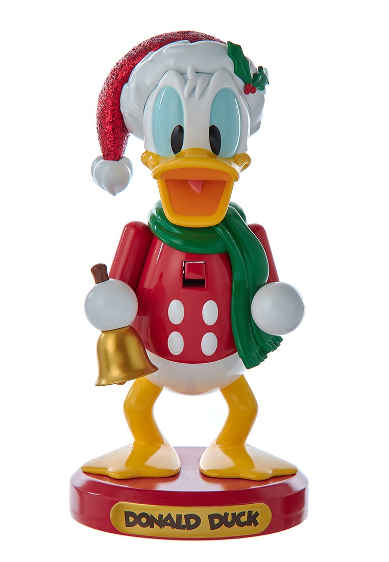 Donald Duck-figuur gekleed voor Kerstmis, met een rode hoed met een witte pompon, een groene sjaal en een rode outfit met witte stippen. Houdt een bel vast.