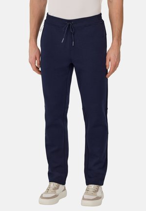 Pantalones de chándal azul marino con cintura elástica y cordón ajustable, con bolsillos laterales y diseño de pierna entallada.