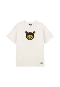 Camiseta de algodón en color crema con un diseño de cara de oso marrón en la parte delantera. Mangas cortas, cuello redondo y una pequeña etiqueta de la marca en la parte inferior izquierda.