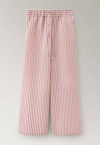 Pantalon ample avec des rayures verticales rouges et blanches, une ceinture élastique et une fermeture à bouton et cordon à l'avant.