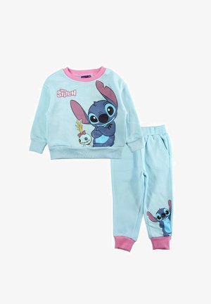 Survêtement en coton bleu clair avec manches longues et pantalon, comportant un motif de personnage cousu. Accents roses sur les poignets et le col.