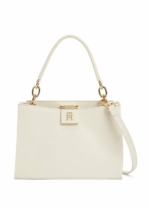 Rektangulær håndtaske i cremefarve med top-håndtag, guldfarvet hardware, lukning med graveret "TH" logo og aftagelig skulderrem.
