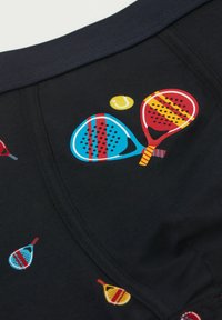 Ropa interior negra con un colorido estampado de raquetas en rojo, azul y amarillo, acompañado de patrones de puntos y una pelota de tenis. Tejido suave y cintura elástica.