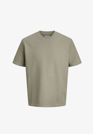 Lyhythihainen, beige teksturoidusta puuvillasta valmistettu t-paita, jossa on pyöreä pääntie ja Jack & Jones -merkitty etiketti kauluksen sisäpuolella.